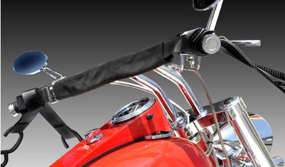 Patented and designed for safely transporting motorcycles, ATVs, and scooters. Adjustable grip covering adjusts to the grip size and eliminates grip damage One size fits all adjustable handle bar cross-strap adjusts from 22"-34" Handlebar cross strap can be adjusted to fit in the best position to avoid damage to gauges, cables, start, headlight, horn buttons and clutch and brake levers. The unique 4 hold down points provide full forward, backward and side to side support, which does not allow for play or rocking motion to occur under whipping motions of a trailer. Can be used on flat bed trailer with no side rails due to the unique 4 point ties. No tire chocks required (although they recommended for added security)